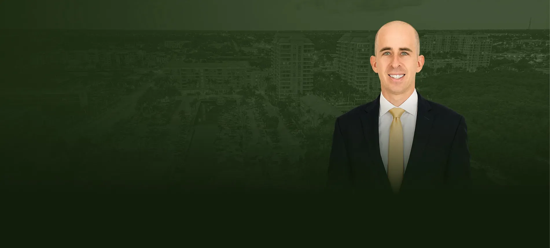 Trial attorney Seth Green in front of an aerial view of Boynton Beach